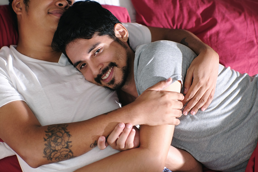 Homosexual Couple Hugging and Relaxing In Bed